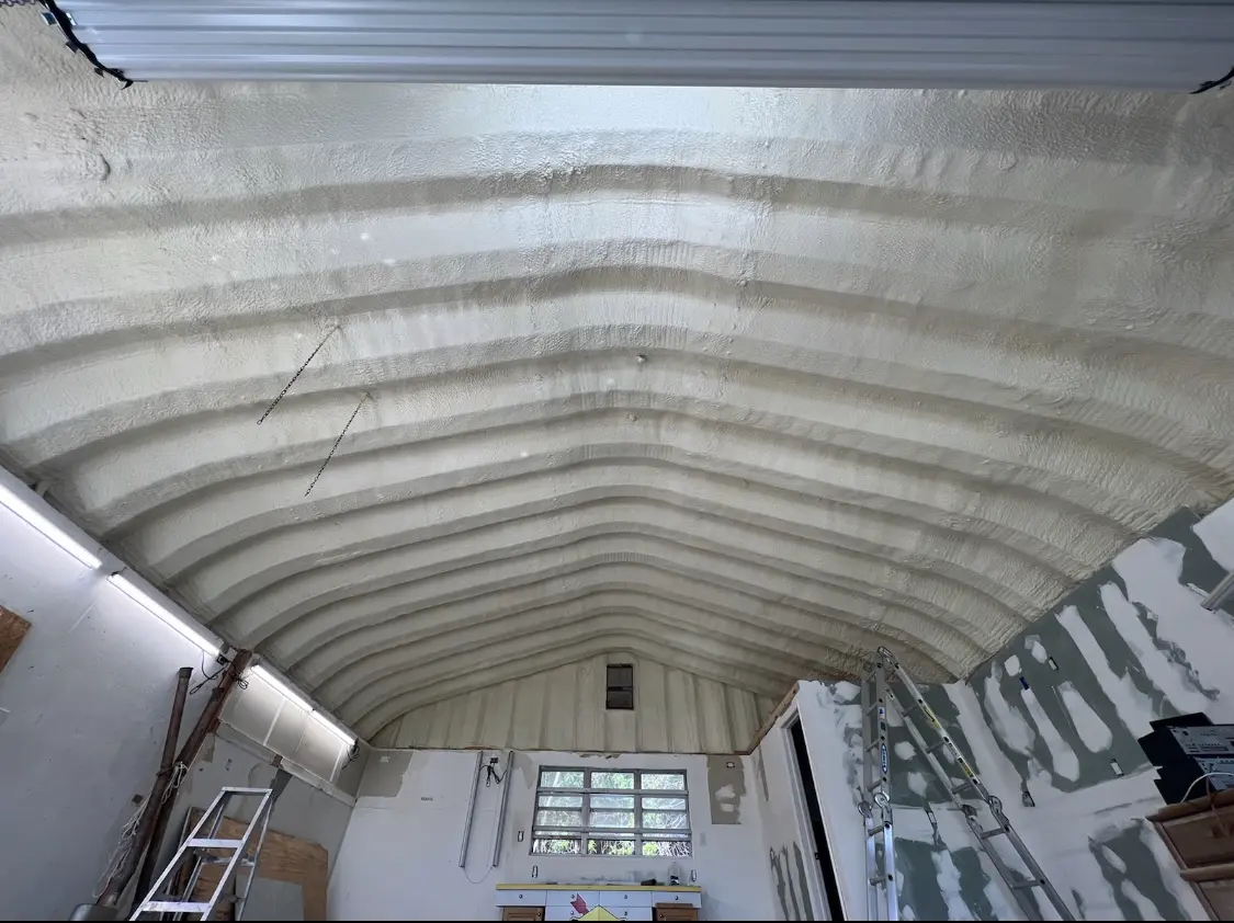 Spray polyurethane foam applied to the underside of a metal roof deck in Red Oak